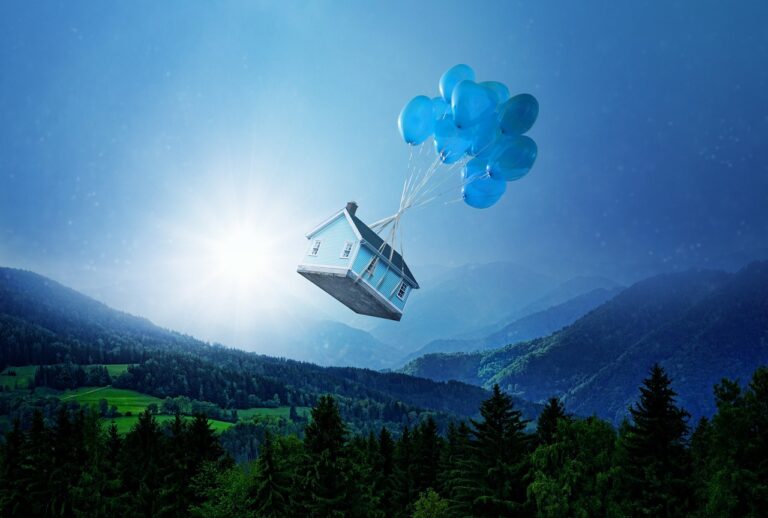 House being carried by blue balloons. Awaken your psyche and imagination with dreamwork.
