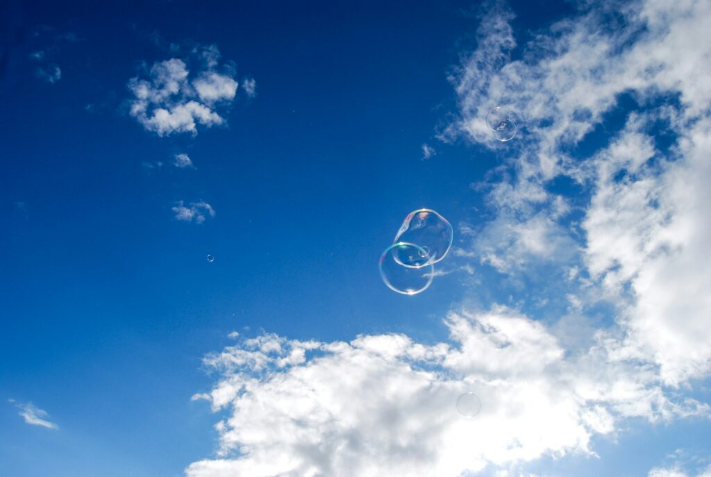Two bubbles in deep blue sky with white clouds. Dreamwork can be fun!