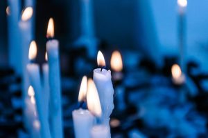 Lit candles with blue background represent spirituality.